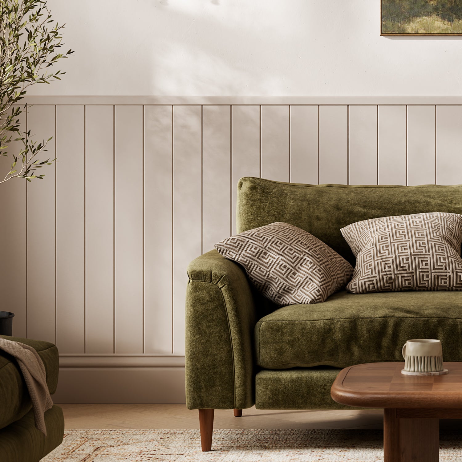 Green sofa with patterned cushions in a living room setting using wall panelling.