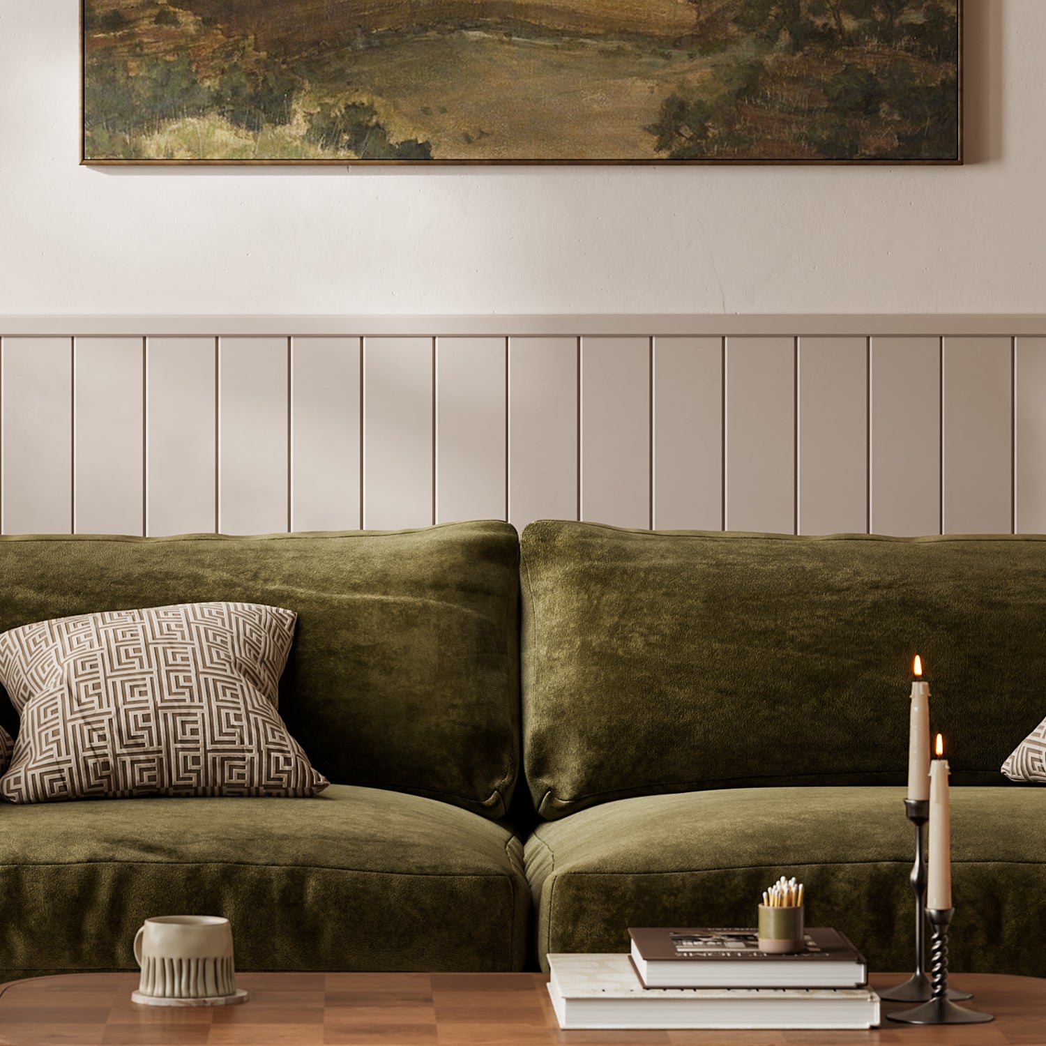 Green sofa with patterned cushions in a living room setting using wall panelling.